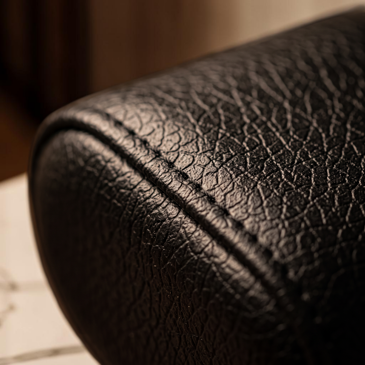 Watch winder cushion in textured black finish with detailed stitching
